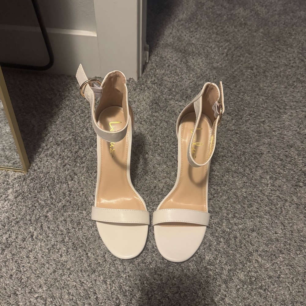 Size 8 white strap on heels.